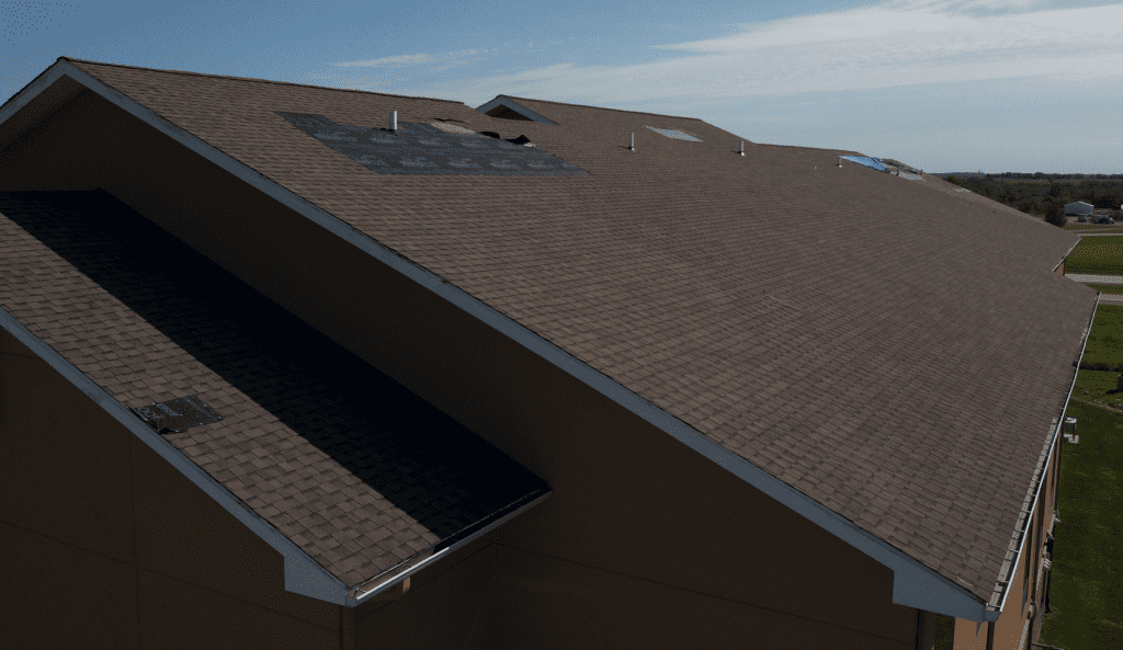Roof Insurance Claims Help 2 Damaged shingles on a hotel roof