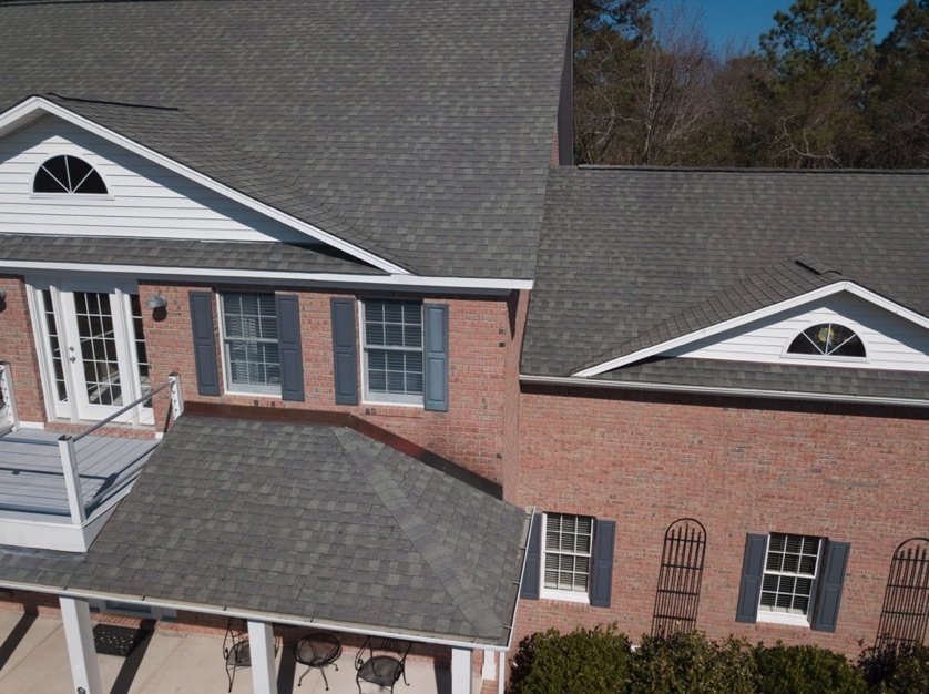 Architectural shingles on a house with brick