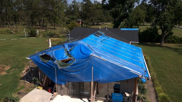 House in rogersville with tornado damage to roof, brick, garage and breezeway missing. Extensive interior damage