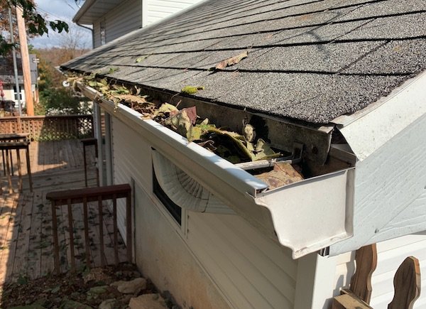 Gutter Install And Repair 1 Gutter with leaves that needs to be cleaned out