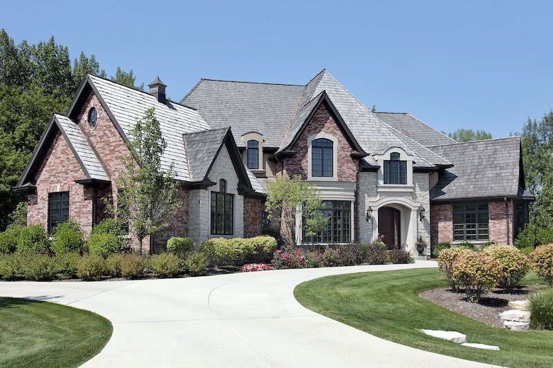 Cook Roofing Co 9 Large brick home in suburbs with circular driveway