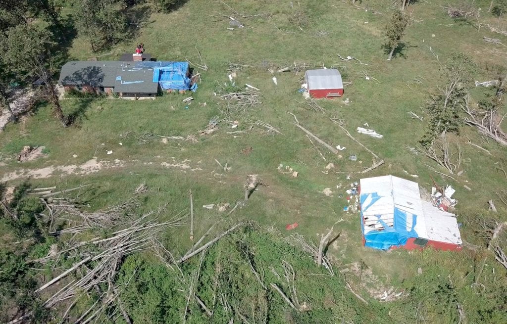 Tornado damaged barns and house
