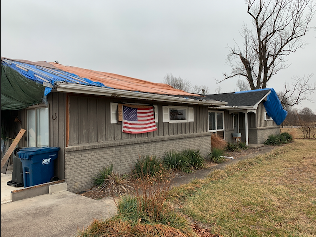 House with severe wind and hail damage to roof, brick, garage and breezeway missing. Extensive interior damage