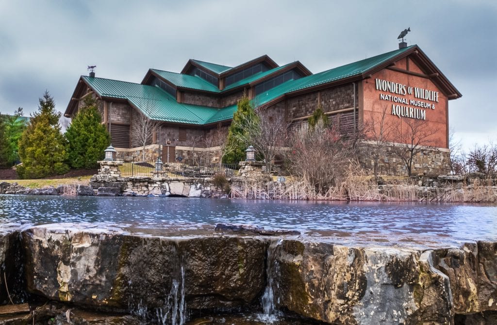 Metal roof repair in corning, mo (6822) - great example of a standing seam roof and premium shingles photo shows pond and waterfall and green metal roof