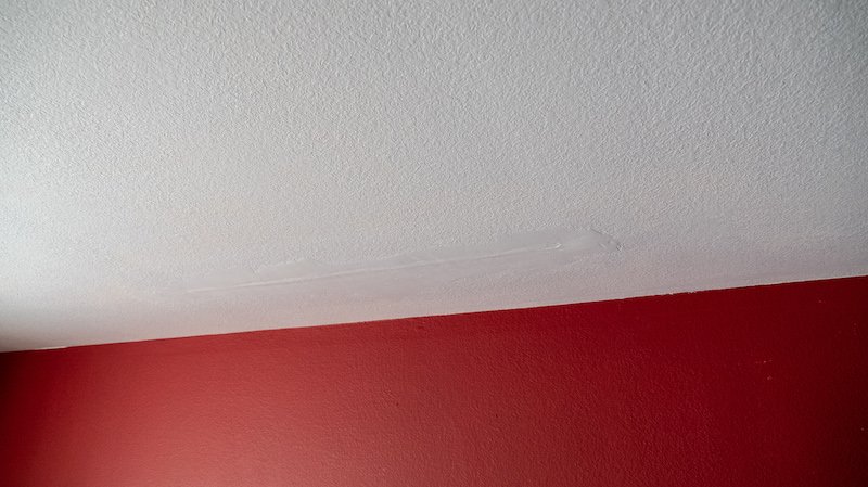 Bad drywall repair from water damage roof leak