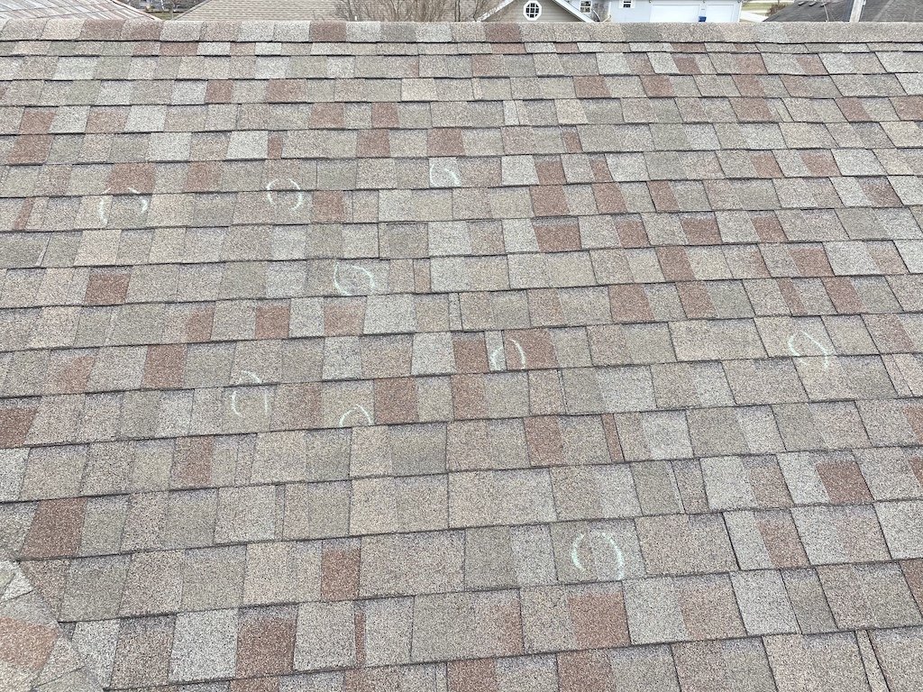 Roof with hail damage marked up with circles showing damage