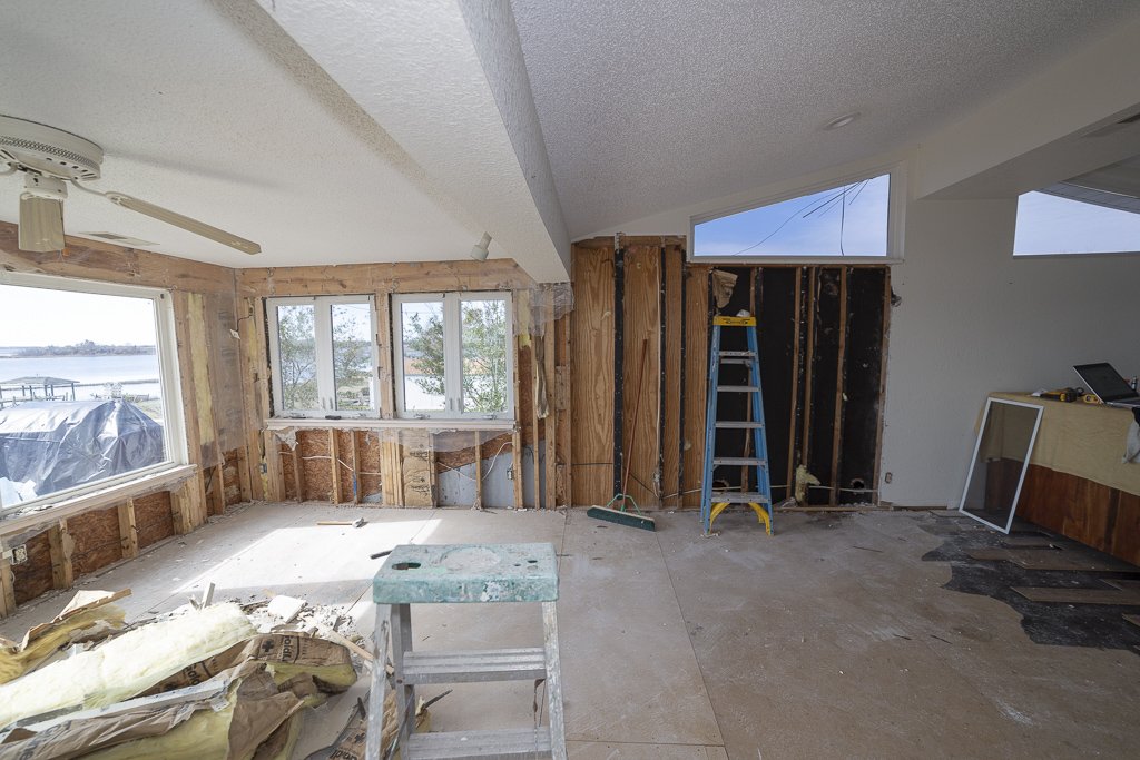 House damaged in hurricane florence with water damage during demolition and exposed stud wall framing and subfloor