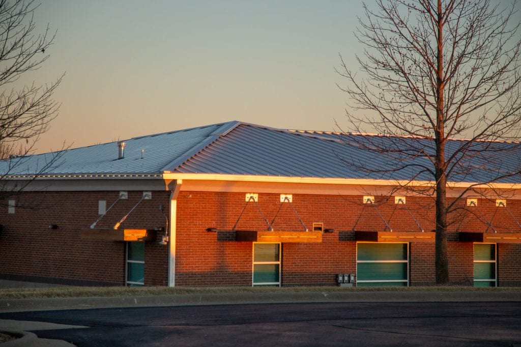 Mitchum jewelers building in nixa with a standing seam metal roof in sunset