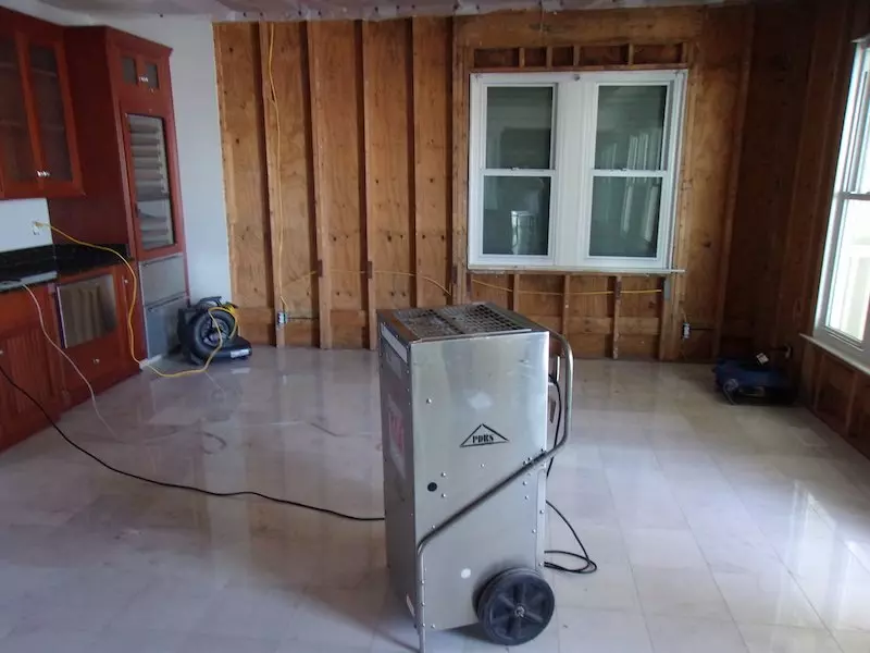 Dehumidifier running to dry room before restoration