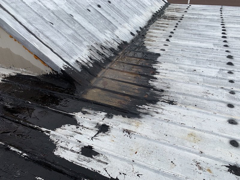 Standing water on metal roof with shallow slope coated with silicone and tar roof is leaking