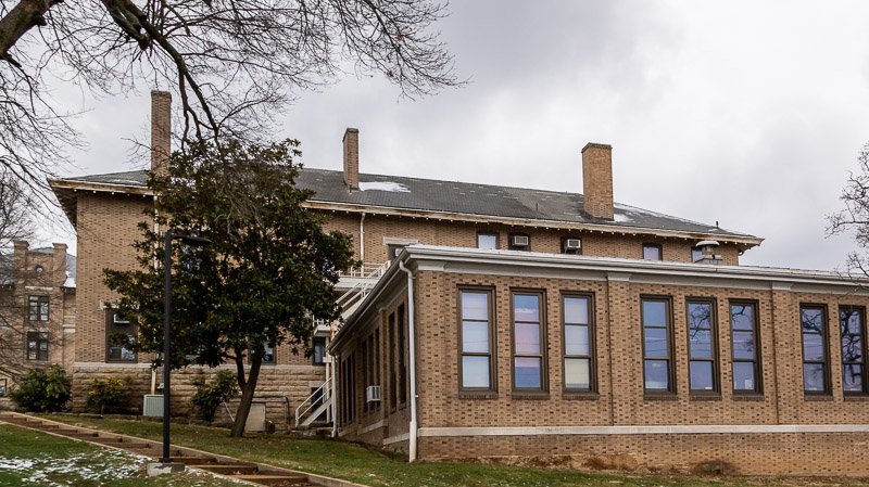 College building in rolla mo with missing shingles from wind damage