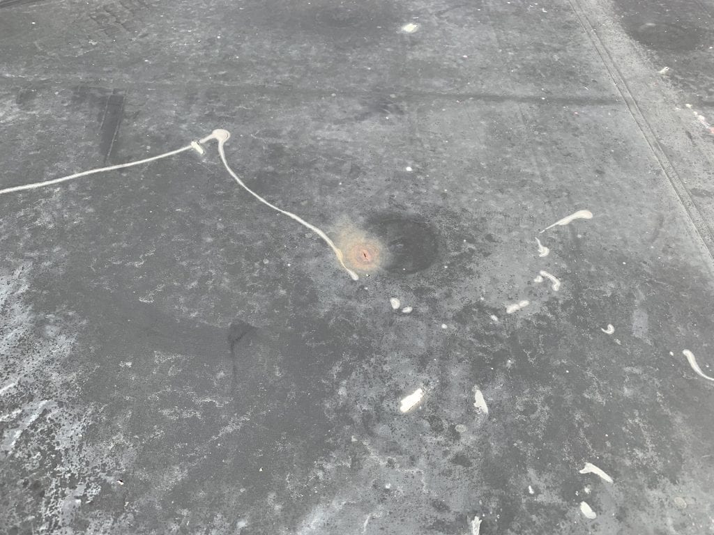 Flat roof repair needed - epdm roofing with a puncture