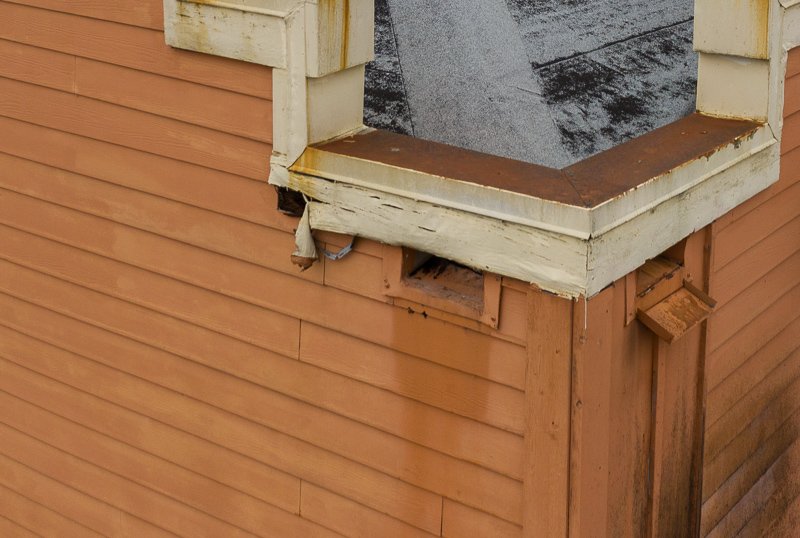 6 Best Types Of Flat Roofs For 2024 3 Scuppers on a restaurant roof with peeling paint and damaged trim