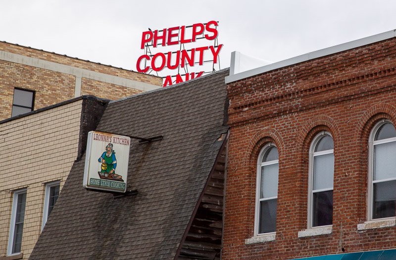 Steep roof with damaged shingles near edge in downtown rolla mo