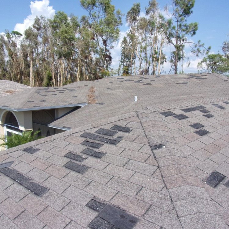 Missing shingles on wind damage roof